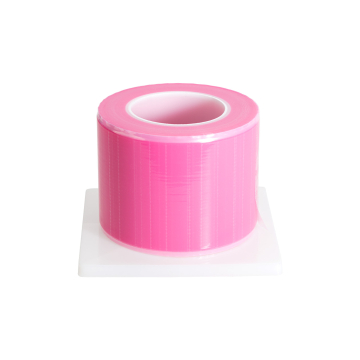 Roll of pink Killer Beauty sheet barrier film on a white dispenser base