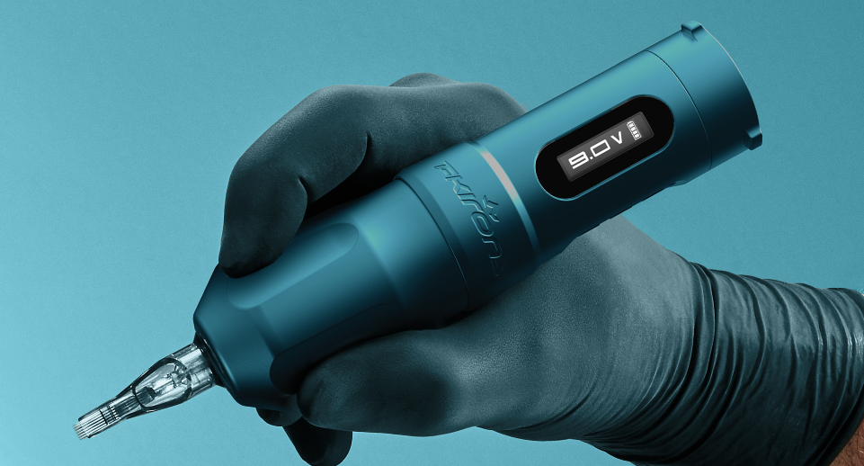 Gloved hand holding a Tidal Flux Max tattoo machine