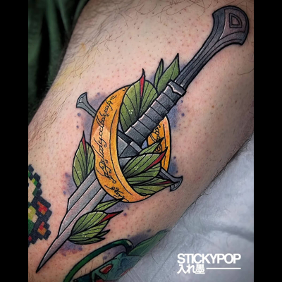 A neo-traditional tattoo by Matt Daniels showing the One Ring circling the broken sword Narsil with leaves around it.