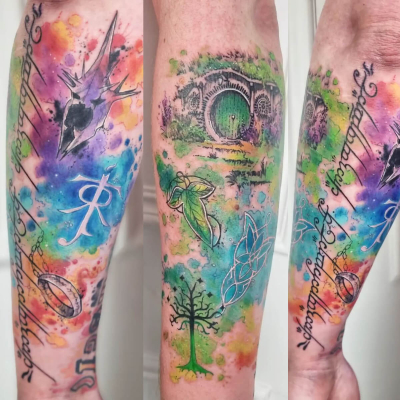 A colourful watercolour tattoo by Joanne Baker showing the One Ring, its inscription, the Witch-king's helmet, a Hobbit door, a leaf of Lorien, the White Tree of Gondor, the Evenstar and J. R. R. Tolkien's monogram.