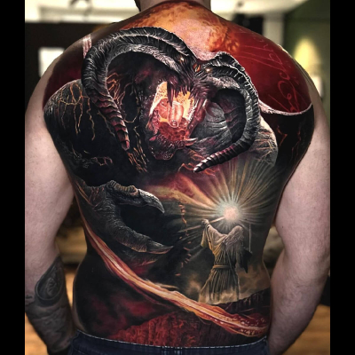 A colour realism full back piece tattoo by Egon Weissberger showing Gandalf on the bridge of Khazad-dûm facing the Balrog.