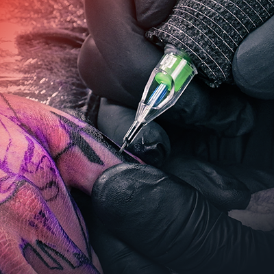 A close-up of someone's finger getting tattooed.