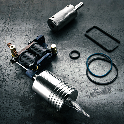 Components of a tattoo machine laid out on a flat surface
